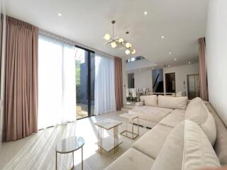 modern living room with large sectional sofa and floor-to-ceiling windows