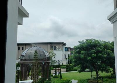 View from window showcasing outdoor area with dome and greenery