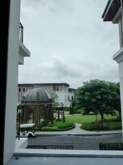 View from window showcasing outdoor area with dome and greenery