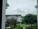 View from window showcasing outdoor area with dome and greenery