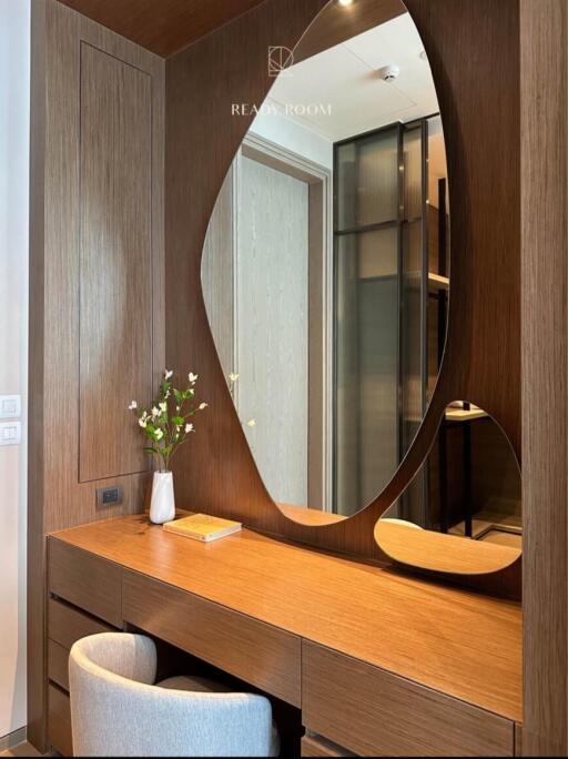 Modern bedroom with wooden vanity desk and mirrors