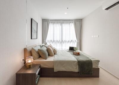 Modern bedroom with large window, bed, and decor