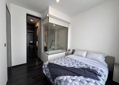 Modern bedroom with glass-enclosed ensuite bathroom