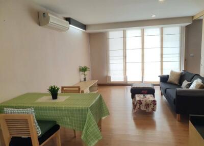 Living room with dining table, sofa, and modern decor