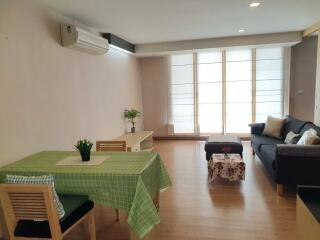 Living room with dining table, sofa, and modern decor