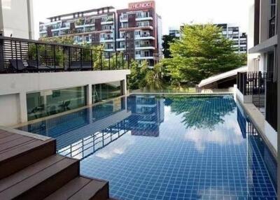 Modern outdoor swimming pool with wooden deck in a residential area