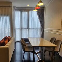 Modern dining area with table, chairs, and a sofa