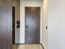 Modern apartment entrance with wooden door and tiled floor