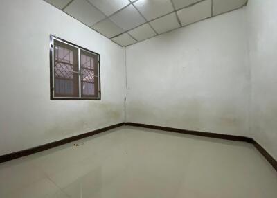 Empty bedroom with tiled flooring and window