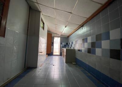 Narrow kitchen with tiled walls and ceiling