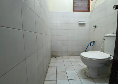 Bathroom with tiled walls and floors