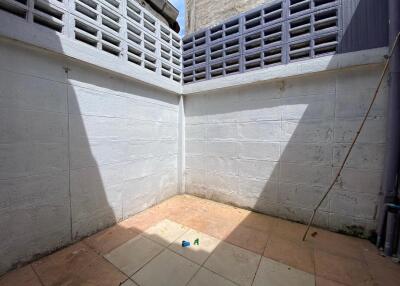 Small enclosed courtyard with tiled floor