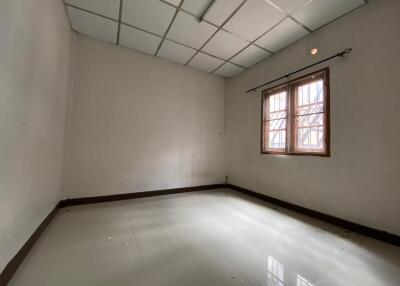 Empty room with tiled floor and single window