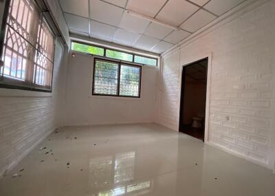 Unfurnished bedroom with white walls and large windows