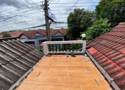 View of the roof showing surrounding houses and trees