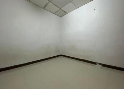 Empty room with white walls and tiled floor