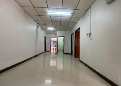 A spacious hallway with tiled flooring and multiple doorways