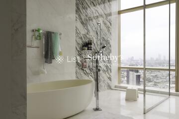 Modern bathroom with a freestanding tub and large windows