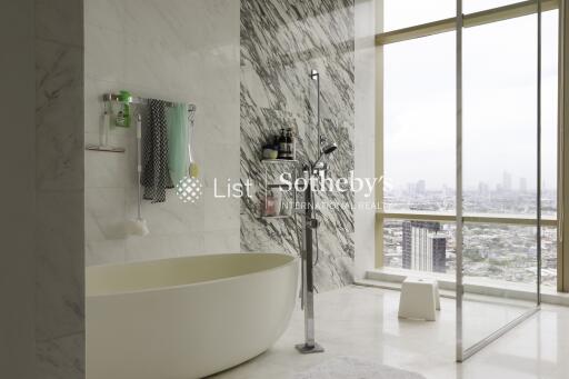 Modern bathroom with a freestanding tub and large windows