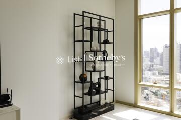 Living room with a metal bookshelf and city view