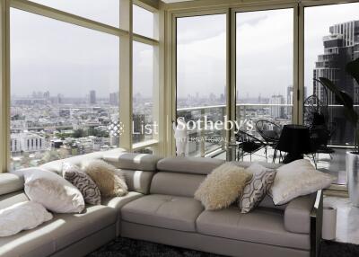 Spacious living room with large windows and city view