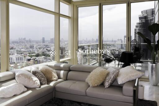 Spacious living room with large windows and city view