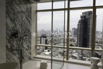 Modern bathroom with marble walls and city view