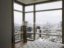 Bedroom with large windows overlooking the city