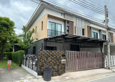 Modern two-story residential building with fenced yard