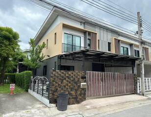 Modern two-story residential building with fenced yard