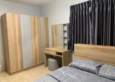 Modern bedroom with wooden furniture and grey curtains