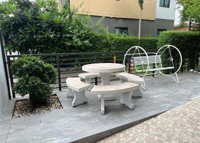 Outdoor sitting area with bench and round table