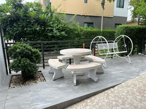 Outdoor sitting area with bench and round table