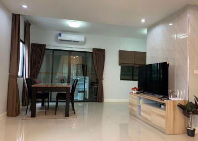 Modern living space with dining area and multimedia setup