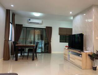 Modern living space with dining area and multimedia setup