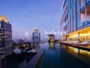 Modern high-rise building with a rooftop pool overlooking the city skyline