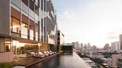 Building exterior with pool and city skyline view