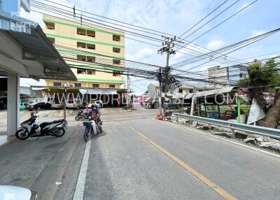 Street view with building, motorcycles, and power lines