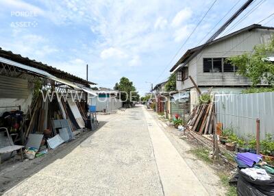 Street view with various houses and construction materials