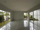 Spacious living room with large windows and garden view