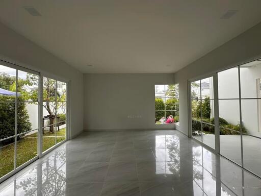 Spacious living room with large windows and garden view