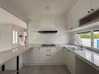 Modern kitchen with white cabinets and countertops