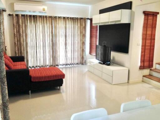 Modern living room with large windows and red sofa