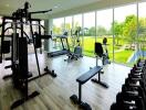 Well-equipped gym with modern fitness machines and large windows