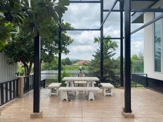 Covered outdoor dining area with picnic table