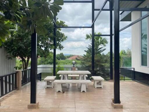 Covered outdoor dining area with picnic table