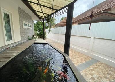 Covered outdoor area with fish pond