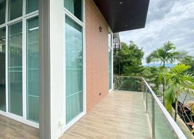 Spacious balcony with glass railing and scenic view