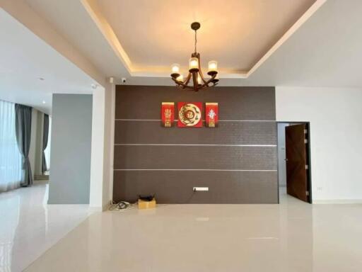 Spacious living room with modern chandelier and wall decorations