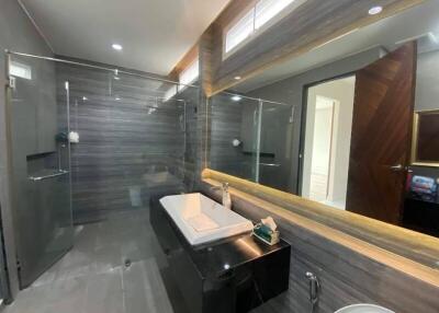 Modern bathroom with glass-enclosed shower and large mirror